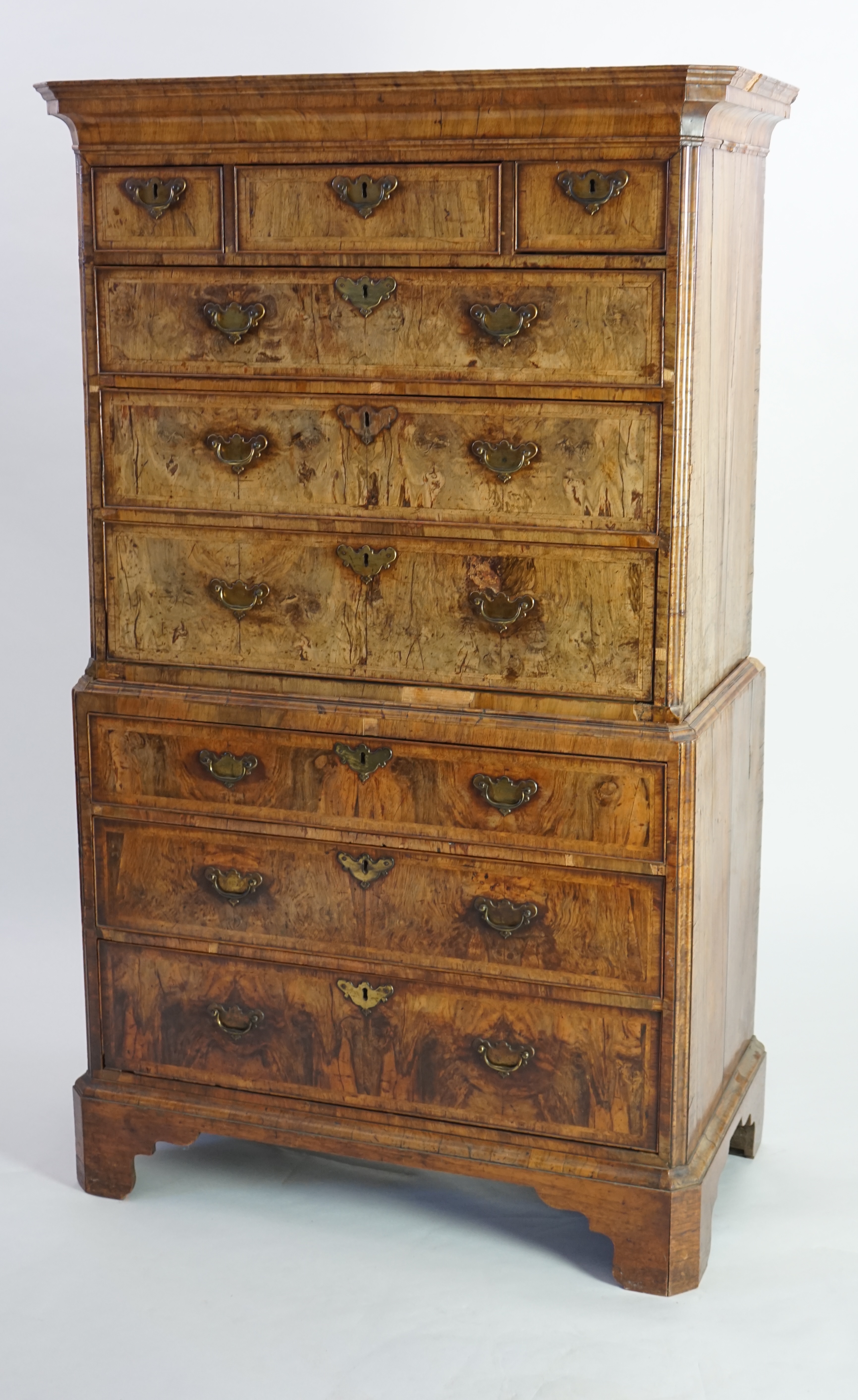 A George II feather banded walnut chest on chest